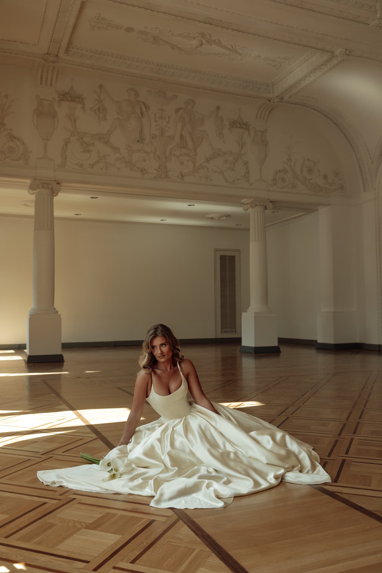 A bride in a wide-flowing BELTED wedding dress